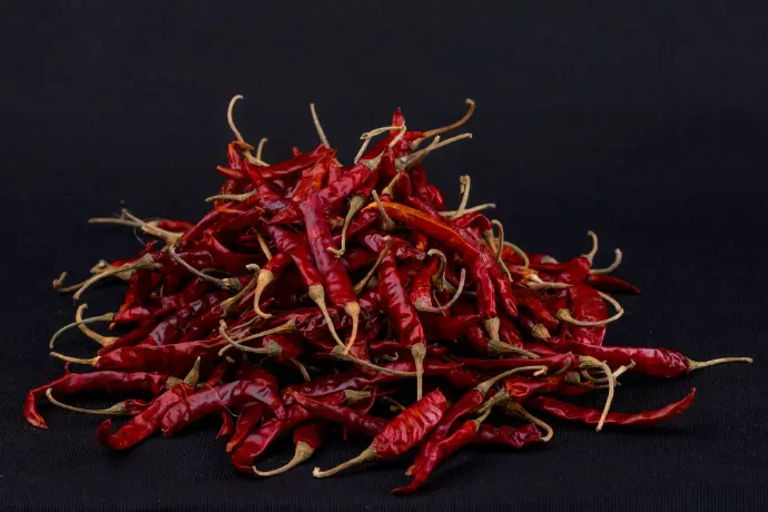 red chili on black surface